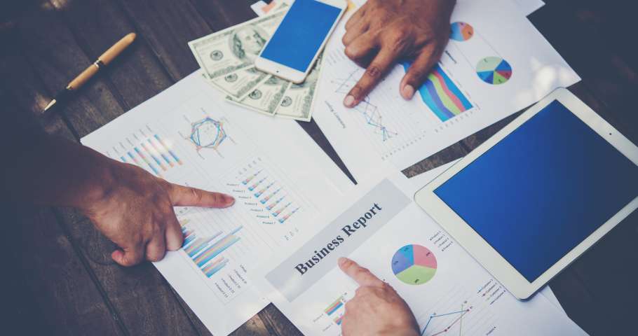 Group of business people analysis with marketing report graph, Young specialists are discussing business ideas for new digital start up project.