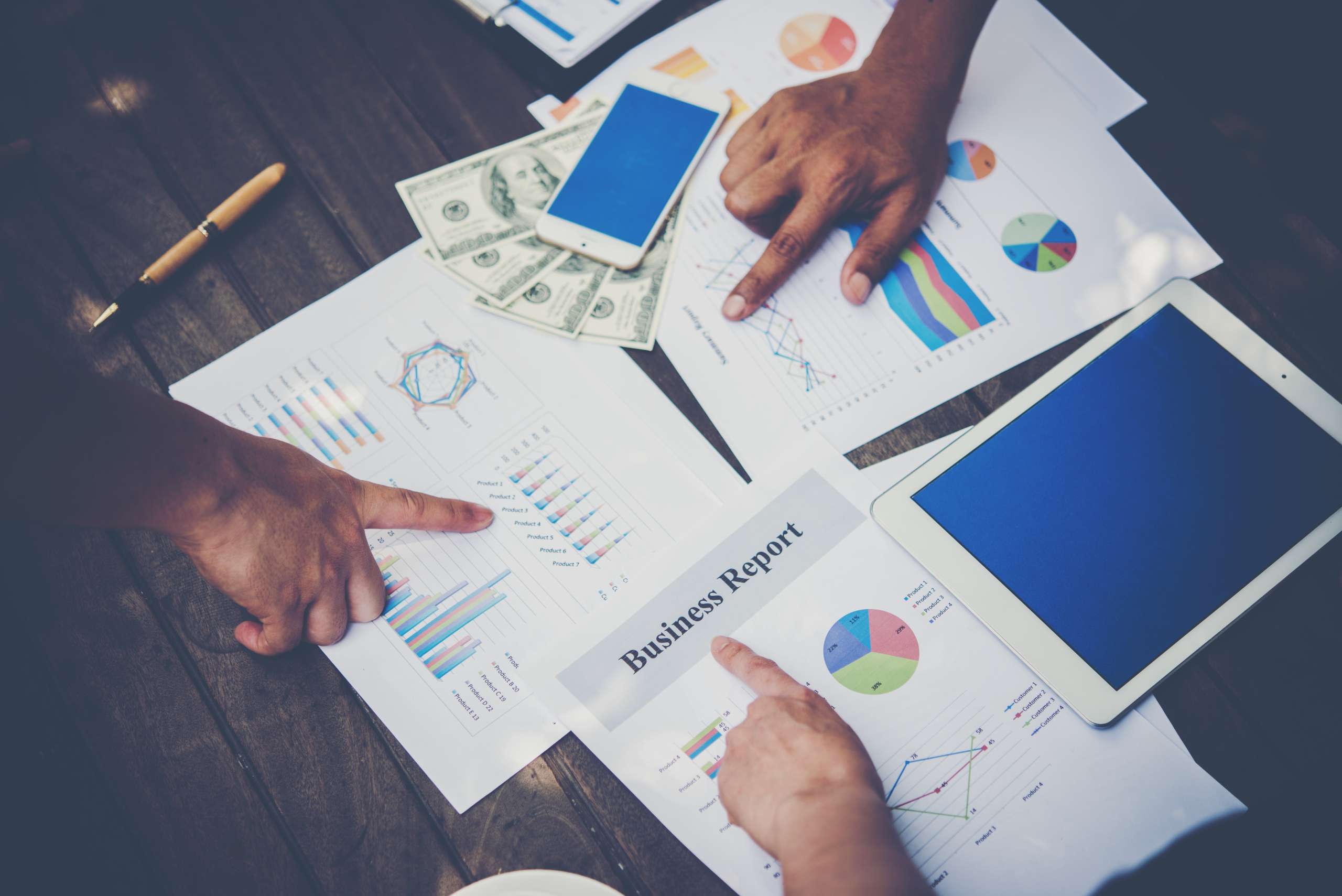 Group of business people analysis with marketing report graph, Young specialists are discussing business ideas for new digital start up project.